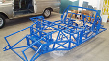 Foreground - GT40 replica chassis awaiting panelwork. Background - Bare metal restoration of Lotus Cortina